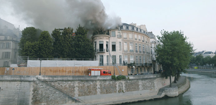 Firefighters battle the blaze at the 17th century Hotel Lambert.
