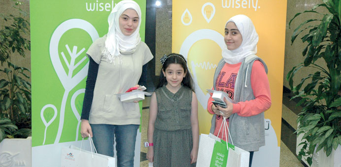 Local people with the kits given by Kahramaa as part of the Tarsheedu2019 campaign.