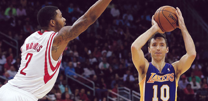 Steve Nash (10) of the Los Angeles Lakers looks to pass over Marcus Morris (2) of the Houston Rockets during their NBA game at Toyota Center in Housto