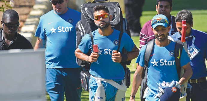  Indiau2019s Virat Kohli (centre) and Ajinkya Rahane leave the nets after a training session in Perth. (AFP)