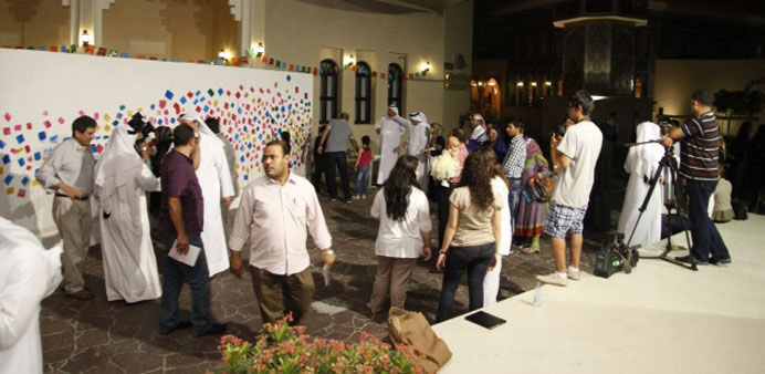 Members of the public putting their dots on the 7mn-long painting.