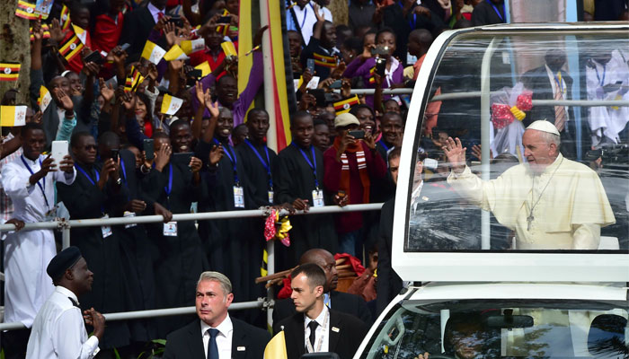 Pope Francis arrives to celebrate an open mass in his popemobile in Kampala, Uganda.