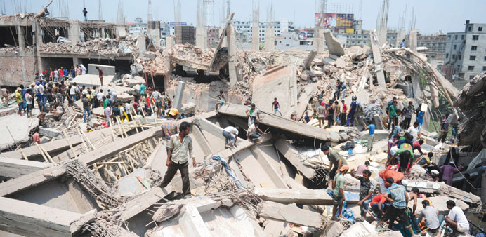 Bangladeshi civilian volunteers assist in rescue operations after an eight-storey building collapsed in Savar, on the outskirts of Dhaka, yesterday.
