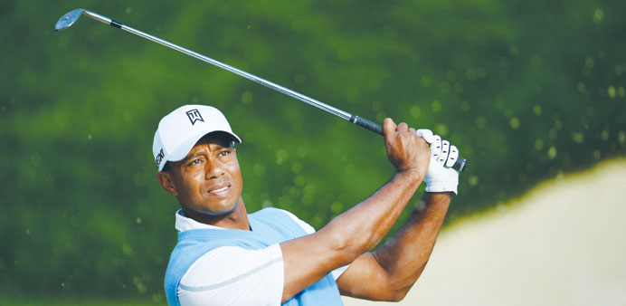 Tiger Woods of the United States plays a shot from a bunker during a practice round prior to the start of the 95th PGA Championship at Oak Hill Countr