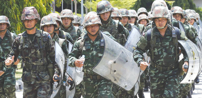 Thai soldiers guarding in the area during a meeting between the army and the main political rivals at the Army Club in Bangkok yesterday.