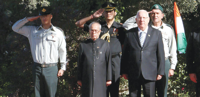 Israeli President Reuven Rivlin and his Indian counterpart Pranab Mukherjee listen to the national anthems during a welcoming ceremony at the presiden