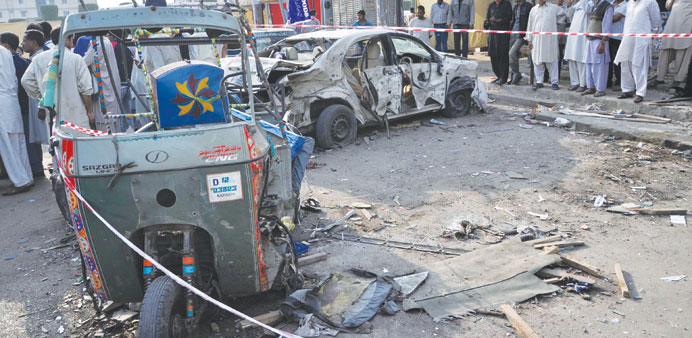 People survey the site of a bomb blast in Karachi yesterday.