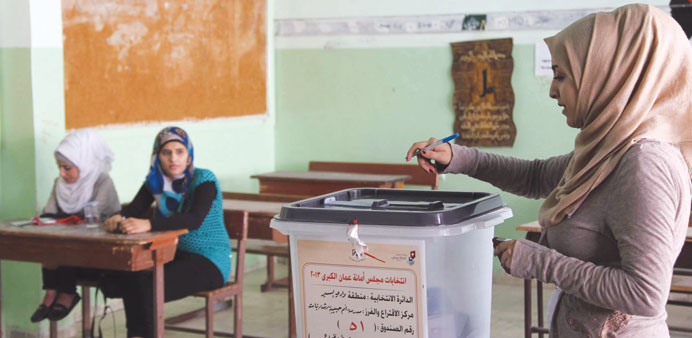 A woman casts her ballot at a polling station in Amman yesterday.