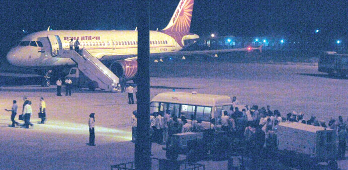 Airport officials transfer the body of Sarabjit Singh to an ambulance after it arrived from Lahore, in Amritsar.