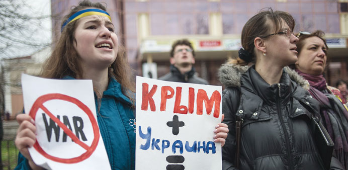 A young woman holds placards reading u2018Crimea and Ukraine equals loveu2019 during a pro-Ukrainian rally in Simferopol.