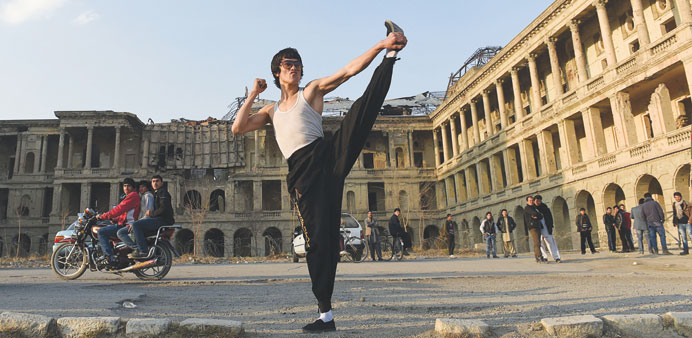 Abbas Alizada, who calls himself the Afghan Bruce Lee, poses at the ruined Darulaman palace in Kabul.