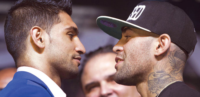 Welterweight boxers Amir Khan of Britain (left) and Luis Collazo of the US fence off during a news conference for undercard boxers at the MGM Grand Ho