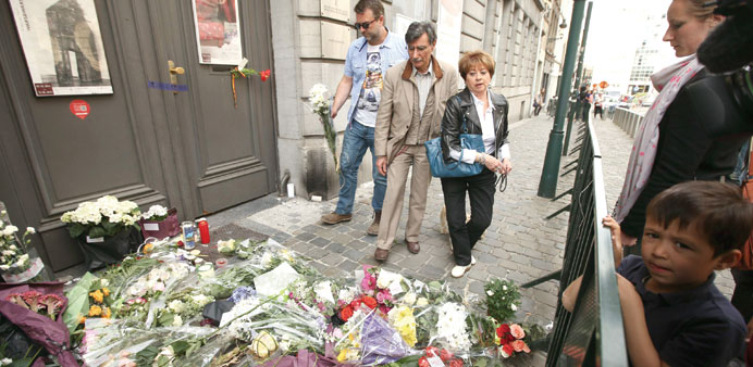 People lay flowers in front of the Jewish Museum in central Brussels yesterday.