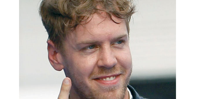 Sebastian Vettel celebrates after taking the pole position at Sepang International Circuit yesterday. (Reuters)