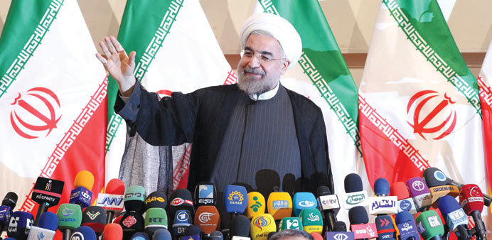  Rohani waves to the media during the press conference in Tehran yesterday.
