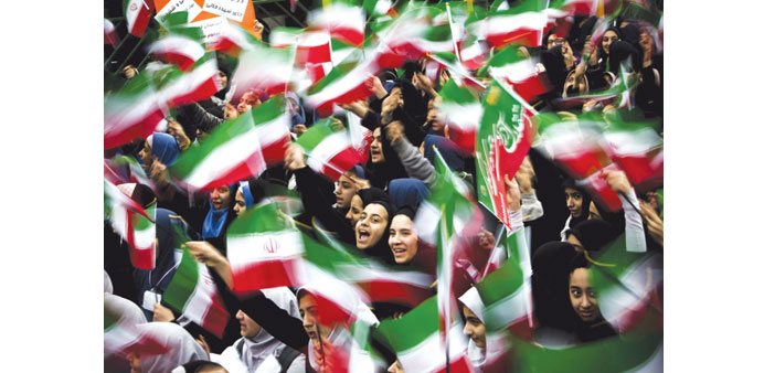 Iranian schoolgirls wave their national flag during the 36th anniversary of the Islamic revolution in Tehranu2019s Azadi (Freedom) Square.