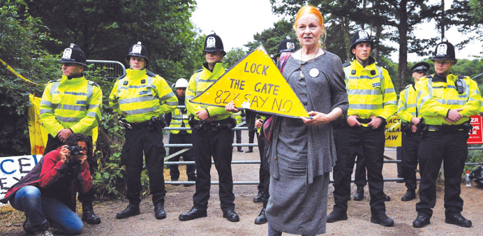 Fashion designer Vivienne Westwood stands with an anti-fracking sign at the gates of the drill site operated by Cuadrilla Resources in Balcombe yester