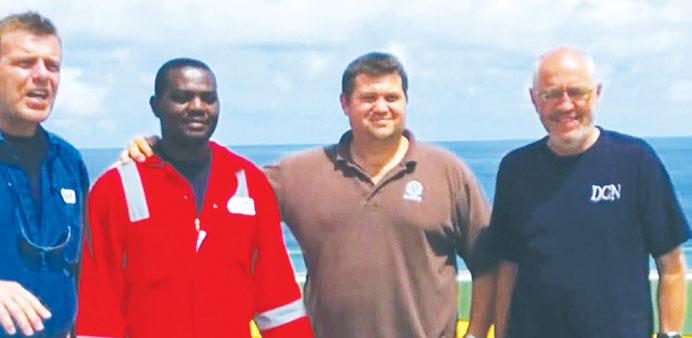 Harrison Odjegba Okene with divers of DCN Diving after they rescued him from his tug boat that sank.