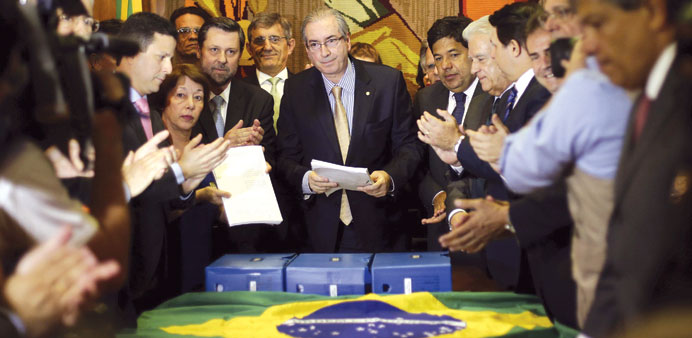 President of Brazilu2019s chamber of deputies, Eduardo Cunha (centre), receives a new petition to Congress for the impeachment of President Dilma Rousseff