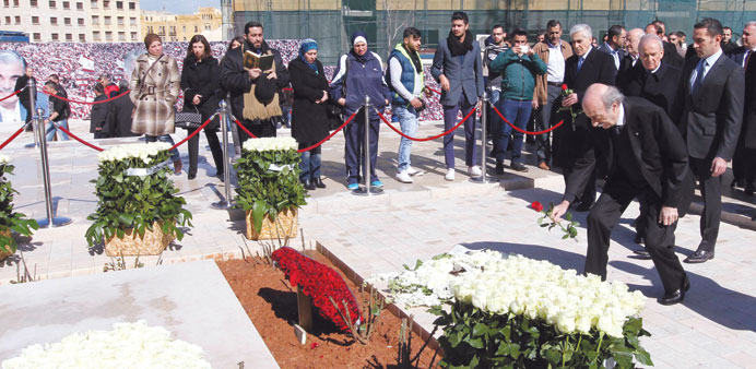 Lebanese Druze leader and Lebanese Progressive Socialist Party (PSP) chairman Walid Jumblatt places a rose on the burial place of slain former Lebanes