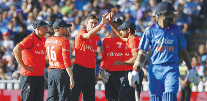 Englandu2019s Chris Woakes (3rd L) celebrates bowling out Indiau2019s Shikhar Dhawan (R) during their T20 match at Edgbaston on Sunday.