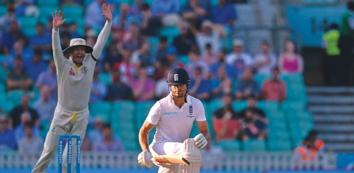 Englandu2019s Alastair Cook (R) reacts after losing his wicket for 85 runs at The Oval cricket ground in London yesterday.