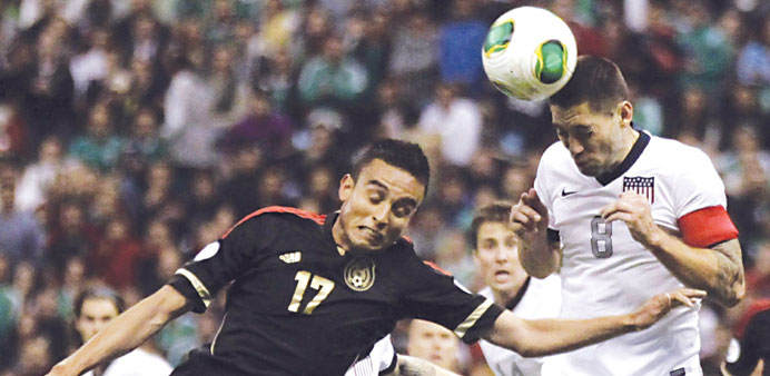 Clint Dempsey (right) of the US heads the ball over Mexicou2019s Jesus Zavala during their World Cup qualifier at Azteca stadium in Mexico City on Tuesday