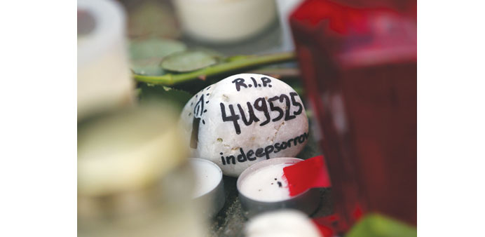 A stone reading u2018RIP 4U 9525 in deep sorrowu2019 lies amidst a memorial of flowers and candles in front of the headquarters of German airline Germanwings 