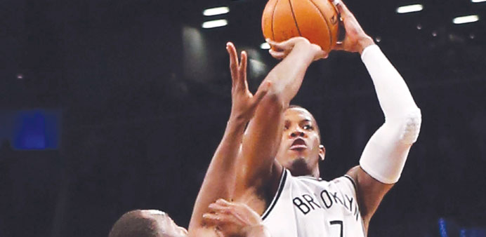 Joe Johnson of the Brooklyn Nets hits a basket with 1.2 seconds remaining in overtime to defeat the Milwaukee Bucks 113-111 at the Barclays Center. (A