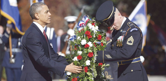    US President Barack Obama lays a wreath at the Tomb of the Unknowns on Veterans Day at Arlington National Cemetery in Washington yesterday.
