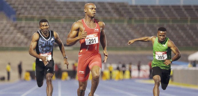 Asafa Powell (centre) competes in the menu2019s 100m during the Jamaican national trials in Kingston, Jamaica, on Thursday. (Reuters)