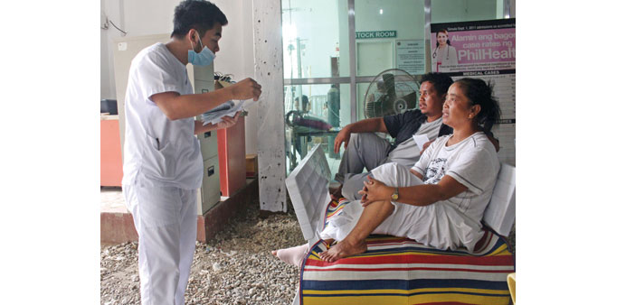 A nurse attends to survivors from a ferry that sank, inside Caraga Regional Hospital in Surigao City, eastern Philippines yesterday.