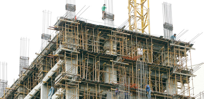 Filipino workers stand on scaffoldings at a construction site in Manila yesterday.
