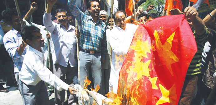 Activists of Shiv Sena shout anti-China slogans and burn a Chinese flag during a protest in Jammu yesterday against the alleged Chinese incursion.