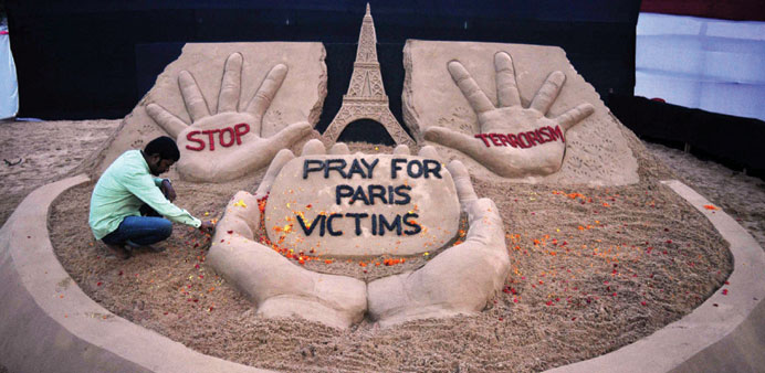 A sand artist finishes a sculpture yesterday in Bhubaneswar paying tribute to the victims of the Paris attacks.