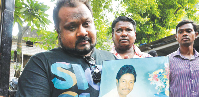 Relatives show a picture of Superintendent of Police Amarjeet Balihar who was killed in a Maoist attack, in Ranchi yesterday.