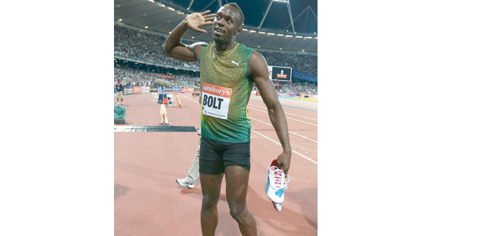    Usain Bolt gestures to the crowd after winning the 100m in London. (Reuters)