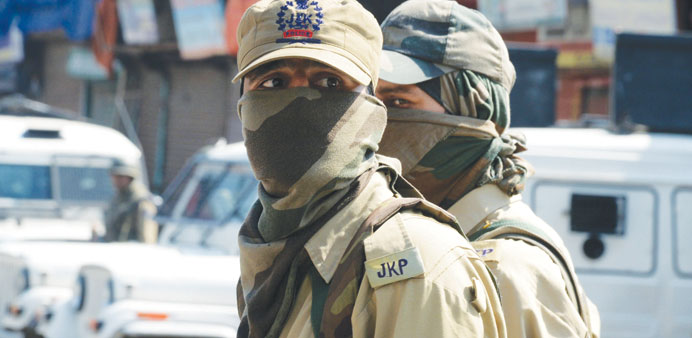 Police stand guard near the site of an attack in Srinagar yesterday.