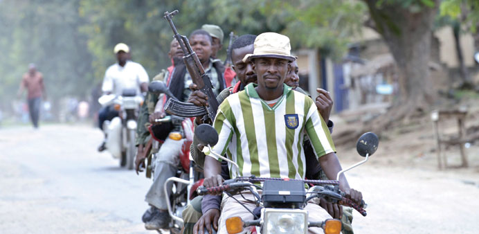 FARDC soldiers ride motorcyle taxis in Kiwanja, a town around 20km from the fighting between troops and rebels yesterday.