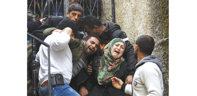 Relatives of Ziad Awad mourn during his funeral yesterday.