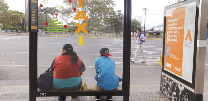 People wait for public transport during the nationwide strike in Buenos Aires yesterday.