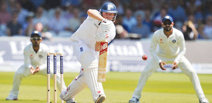 Englandu2019s Gary Ballance (centre) plays a shot on day two of the second Test against India at Lordu2019s Cricket Ground in London yesterday. (AFP)
