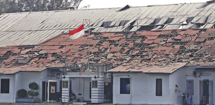 An Indonesian flag is seen at a Navy ammunition warehouse, after an explosion took place in Pondok Dayung island, Jakarta yesterday.