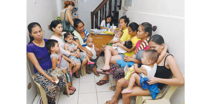 Mothers with children queue at Likhaan centre for womenu2019s health to consult for free family planning methods in Manila yesterday.