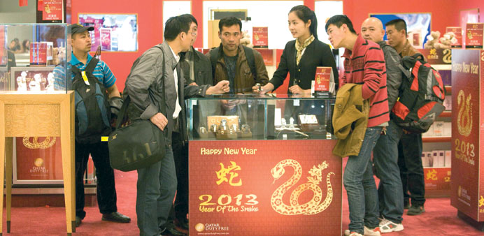 Passengers check out the promotions at the Doha International Airport (DIA) as part of the Chinese New Year celebrations.