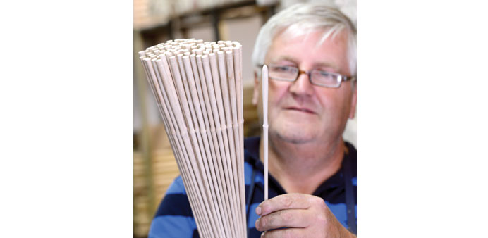 Matthias Hellinger, chief executive of the Rohema company, checks a handful of batons. The firm makes orchestral batons at Markneukirchen in Saxony, 