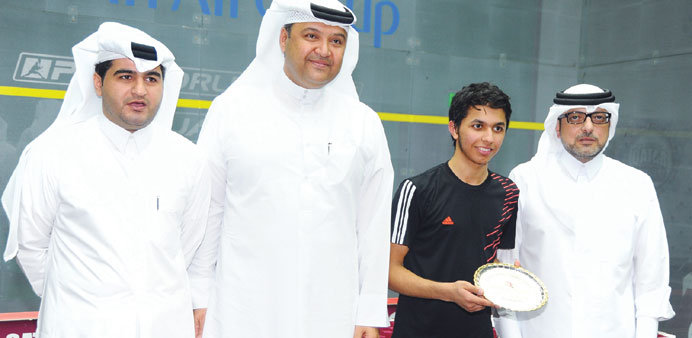   Abdulla al-Tamimi poses with his trophy along with Qatar Squash Federation (QSF) President Nabeel Ali bin Ali (right) and other officials at the Kha