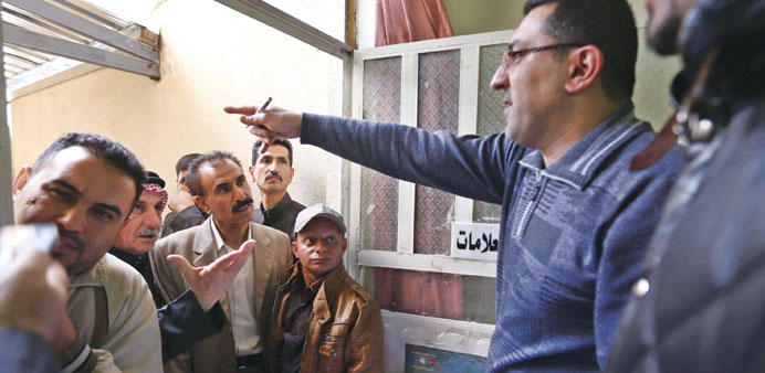 Sunni Muslim Iraqis, who fled Fallujah, register their names at the Ministry of Displacement and Migration office in Arbil yesterday.