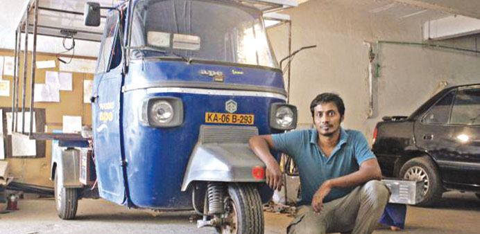 Naveen Rabelli with his solar-electric powered auto-rickshaw.