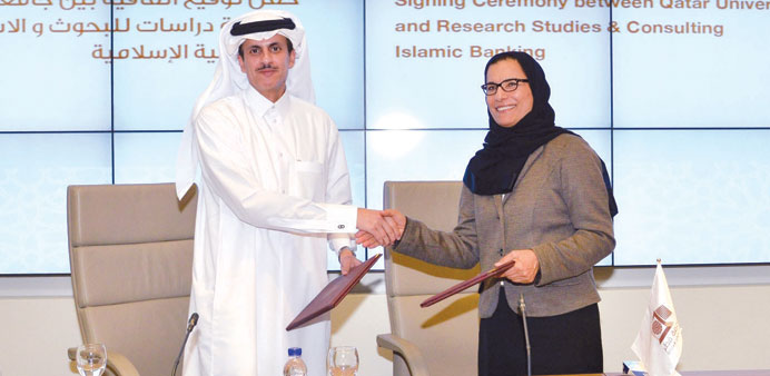Professor Sheikha Abdulla al-Misnad with Sheikh Dr Khalid bin Thani bin Abdullah al-Thani at the signing ceremony.